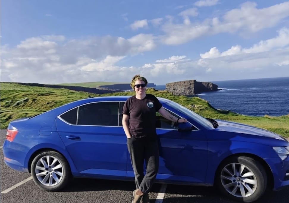 Cat Magill beside her car on the coast road near Doolin, County Clare