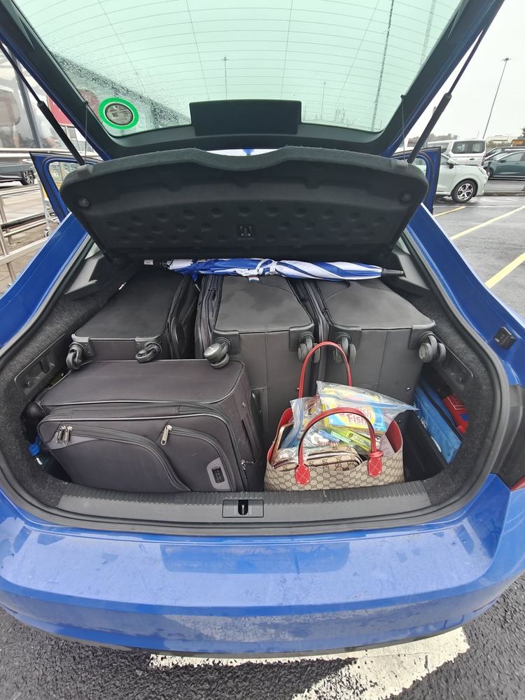 The boot of Cat's car loaded with suitcases and bags