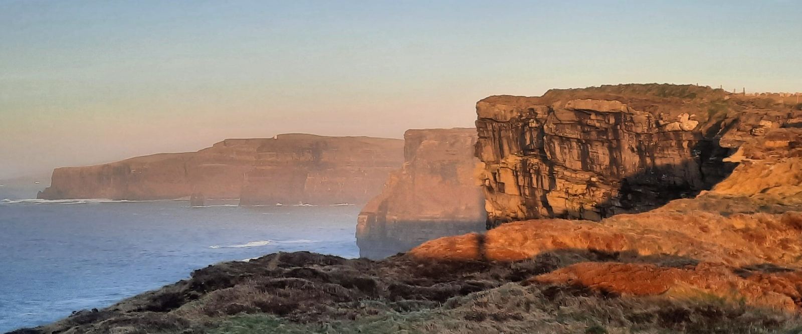 The Cliffs of Moher in low golden evening light